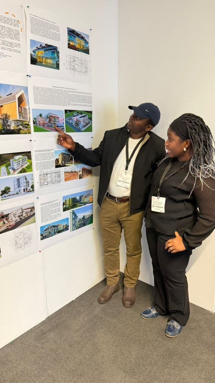 Oluyemisi talking a visitor through her boards at the Surface Design Show